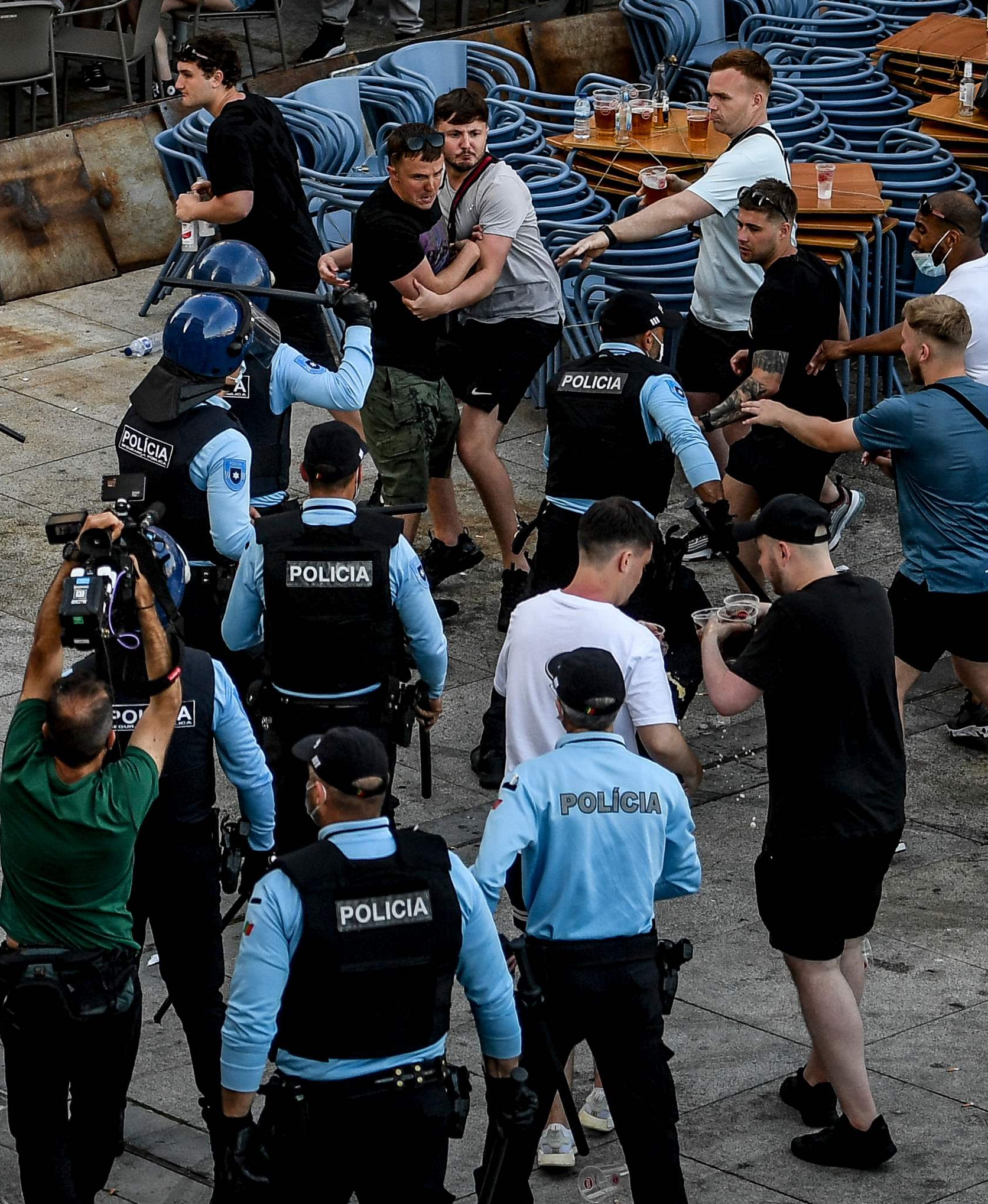 Riot police threaten rowdy fans with batons